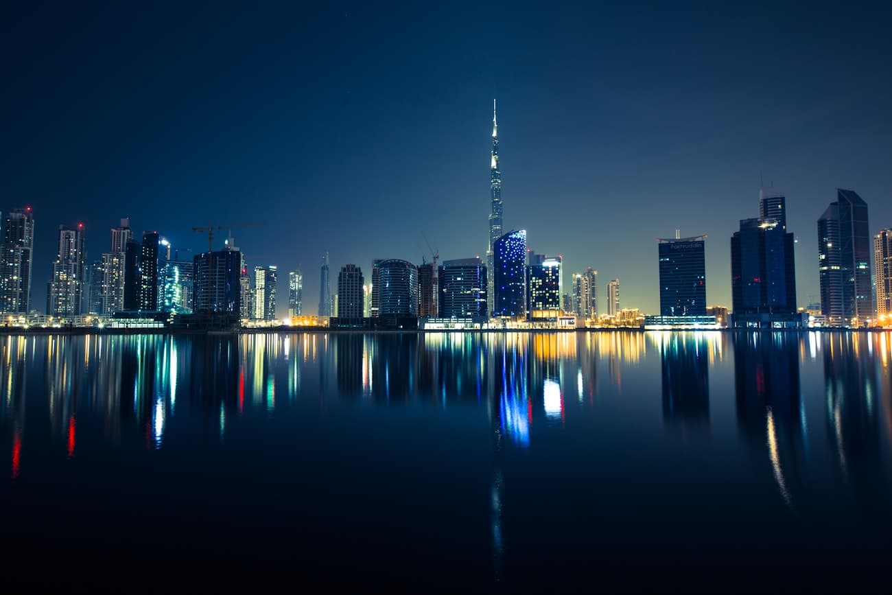 Dubai skyline reflected in the water after dark